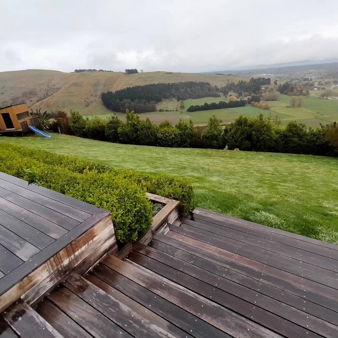 Freshly mown lawn and trimmed hedge beside a deck, Canterbury